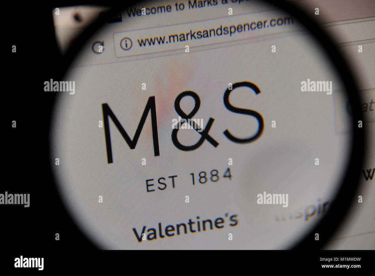 The Marks and Spencer website seen through a magnifying glass Stock Photo