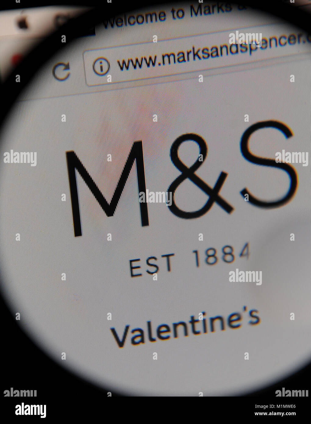 The Marks and Spencer website seen through a magnifying glass Stock Photo