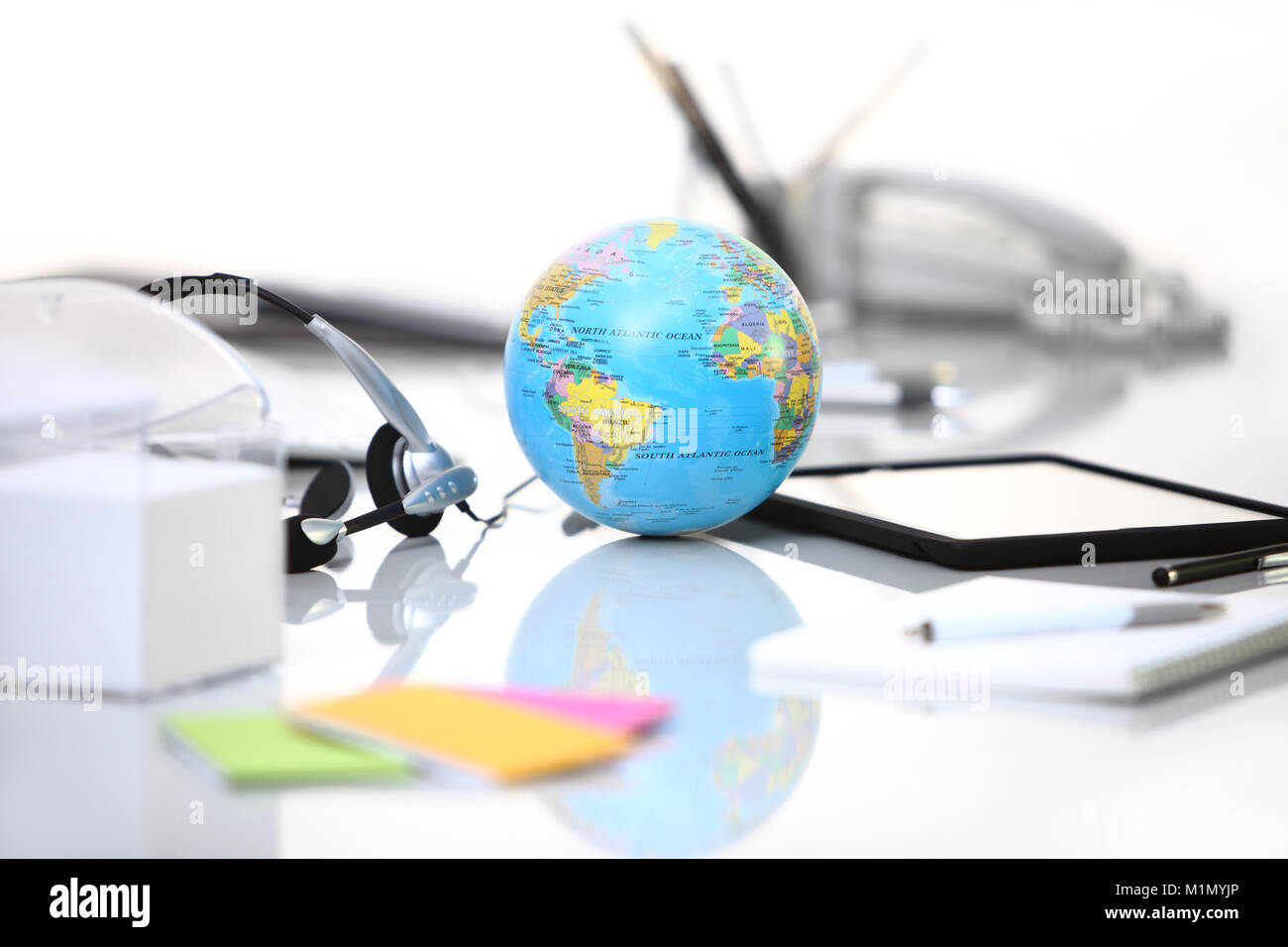 Office Desk With Tablet Headphones And Globe Stock Photo
