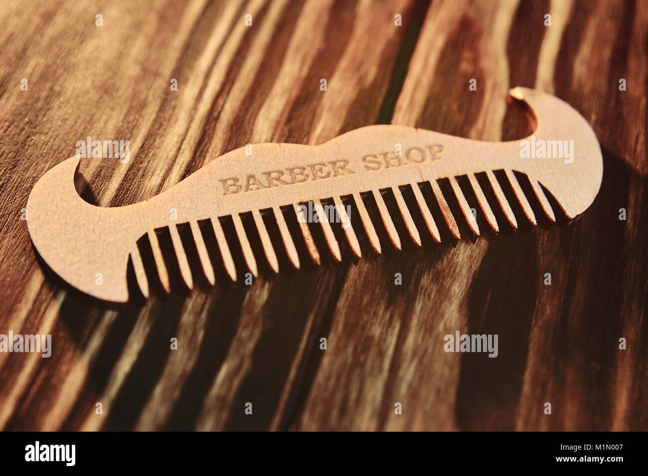 Wooden comb in the form of a mustache with the inscription