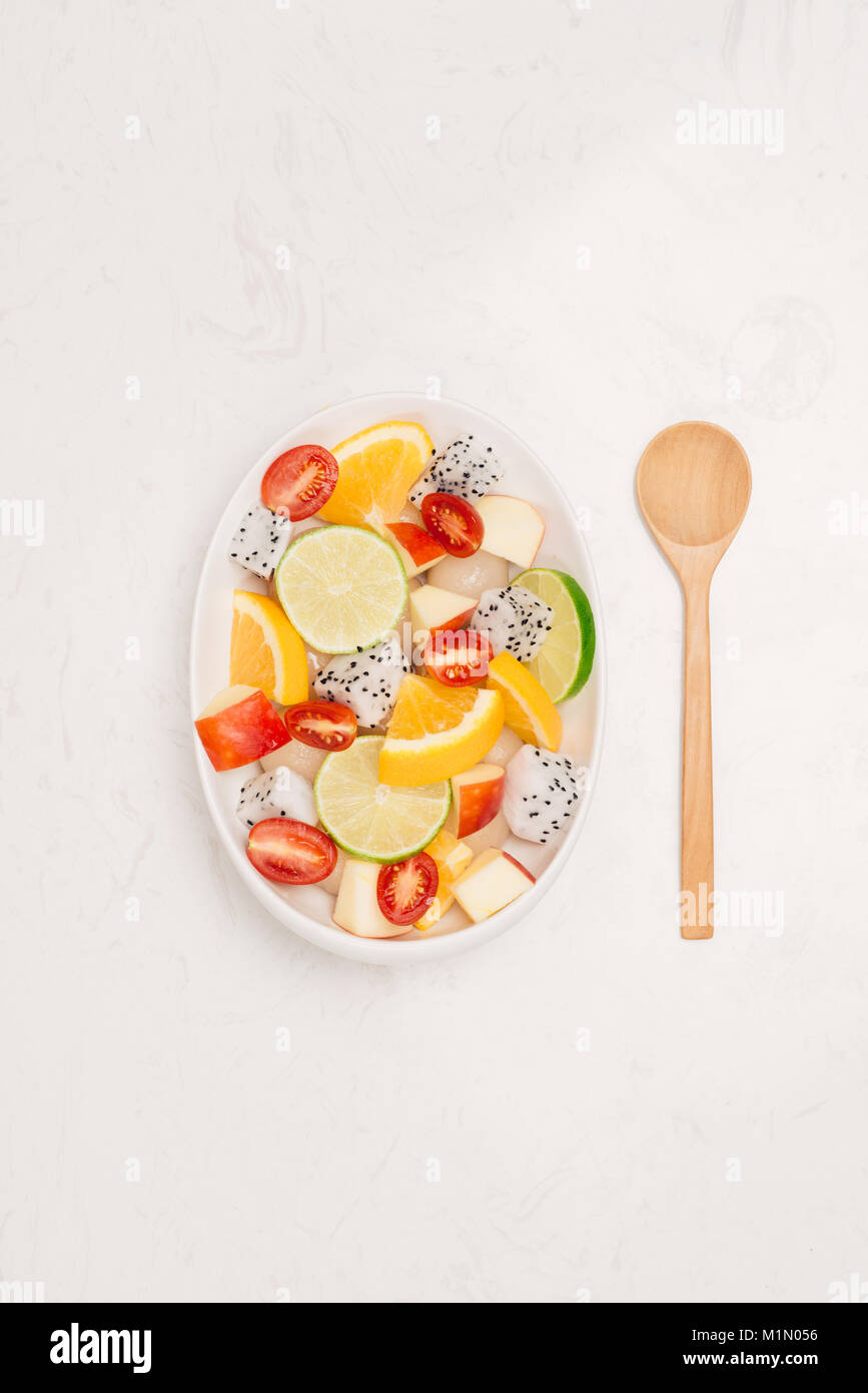 Fresh mixed fruit salad falling into a bowl of salad Stock Photo - Alamy