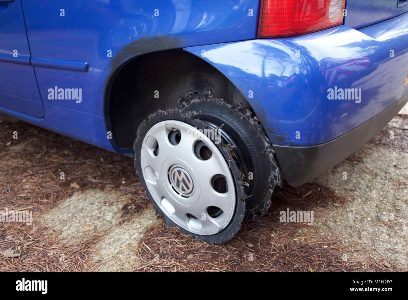 Pothole damage to car Stock Photo