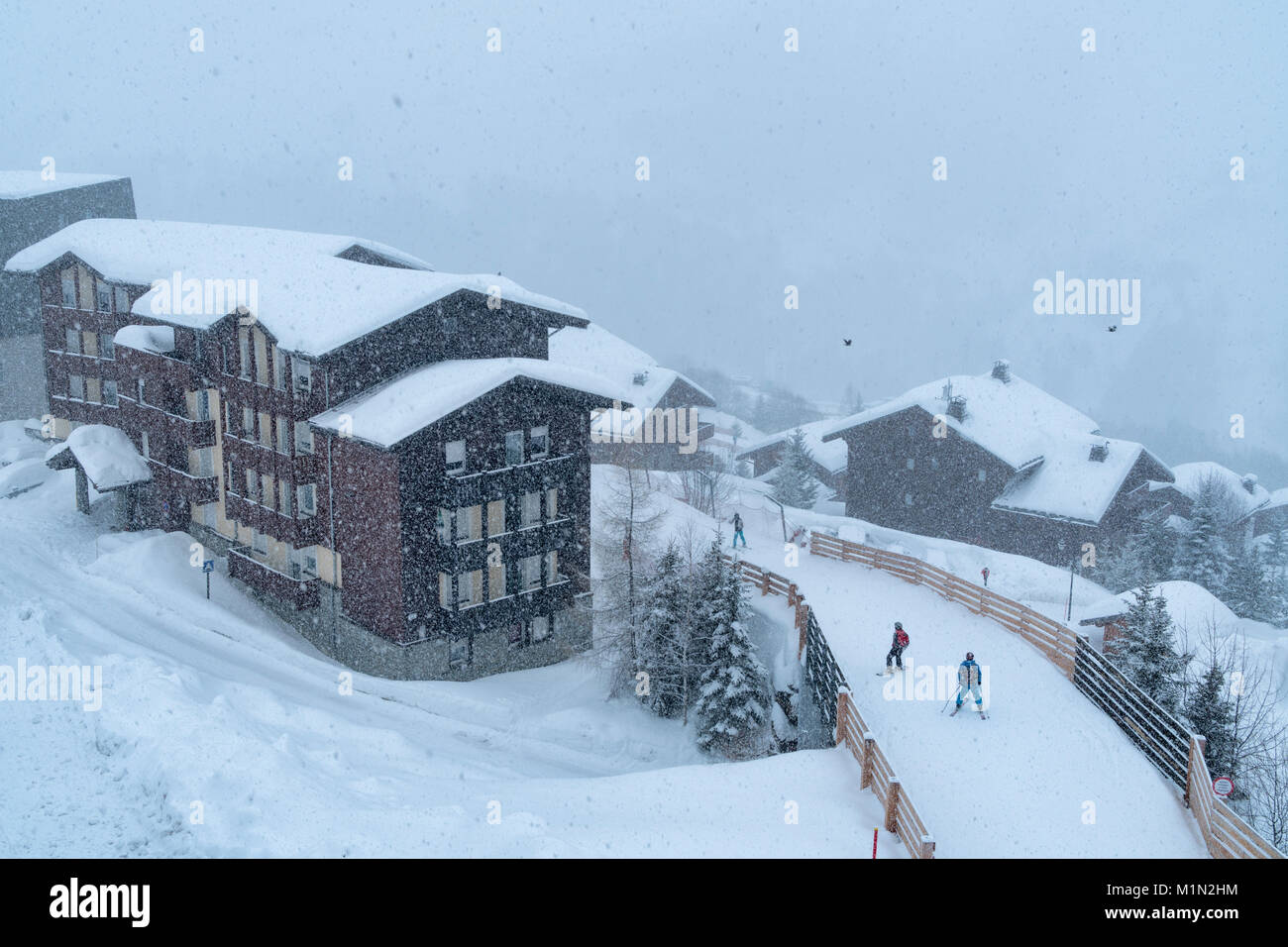 View of chalets in the Bettix area of Les Menuires in the 3 Valleys ski area on a very snow day. Stock Photo