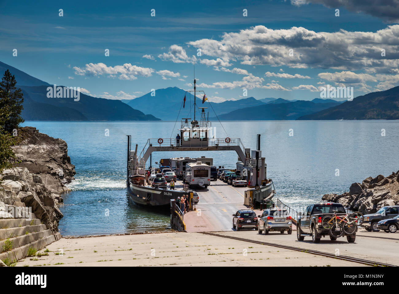 Vehicles entering MV Galena ferry in Shelter Bay to cross Upper Arrow Lake to Galena Bay, Monashee Mtns, West Kootenay, British Columbia, Canada Stock Photo