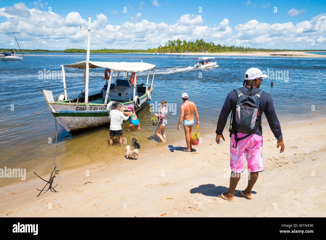 CAIRU, BRAZIL - FEBRUARY 15, 2017: A Brazilian boat captain waits for tourists to board for a day trip. Stock Photo
