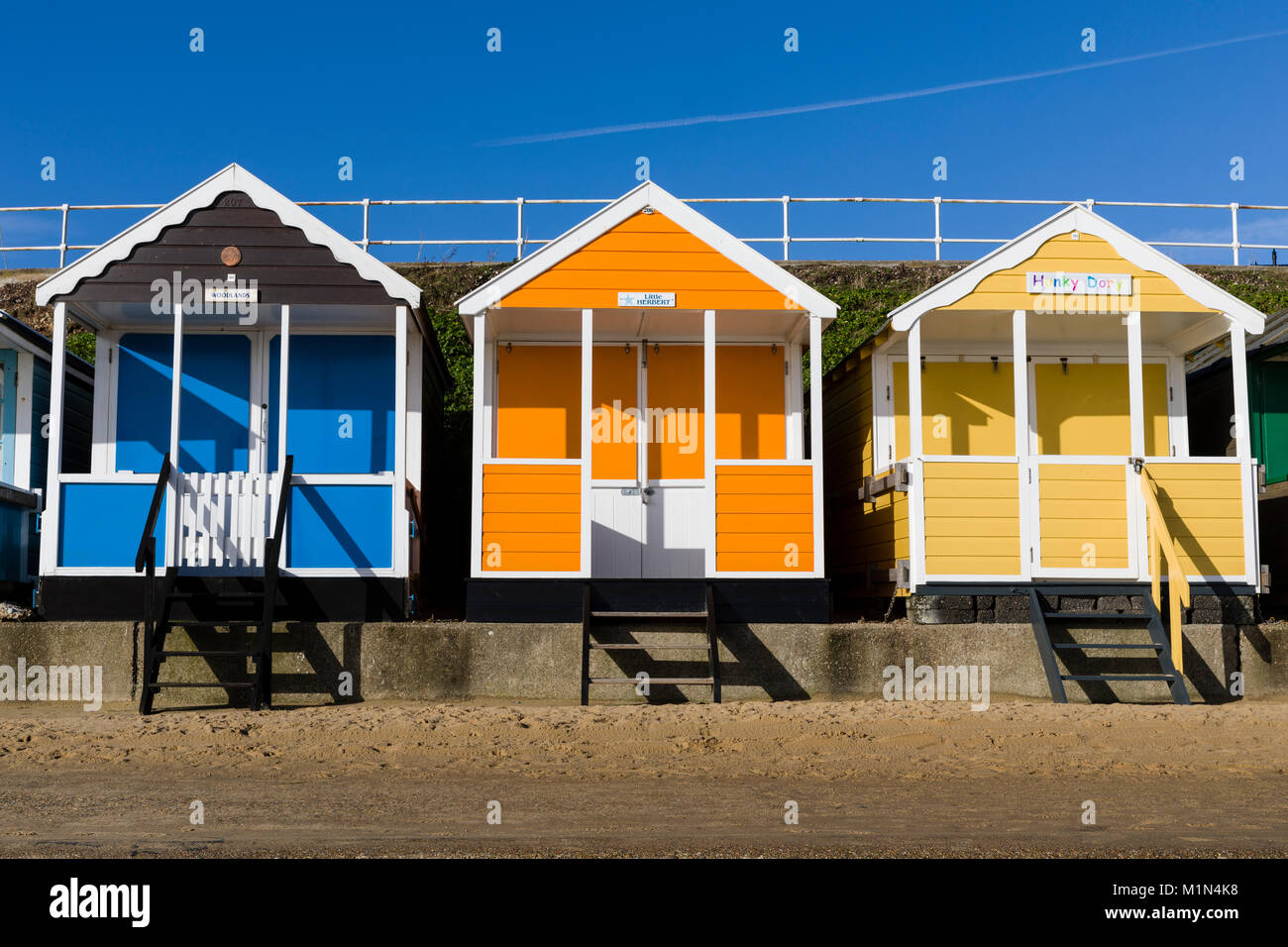 Traditional Seaside Beach Huts with a brilliant Blue Sky backdrop on
