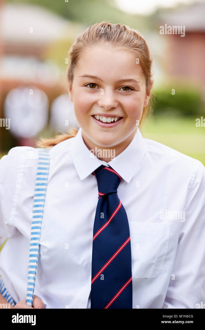 Portrait Of Female Teenage Student In Uniform Outside Buildings Stock Photo