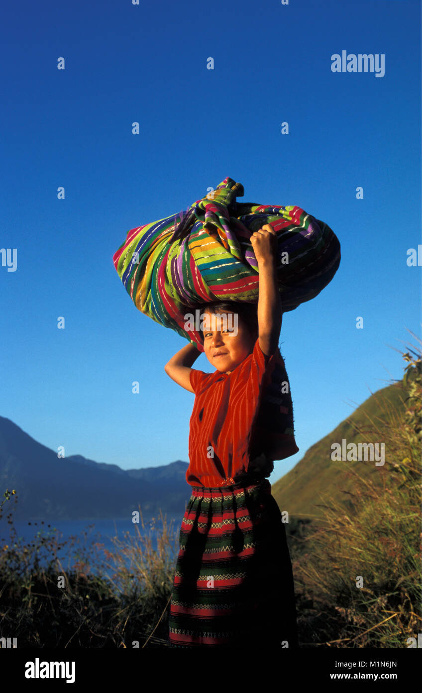 Guatemala. Panajachel. Lago de Atitlan. Maya girl carrying pack on head. Portrait. Stock Photo