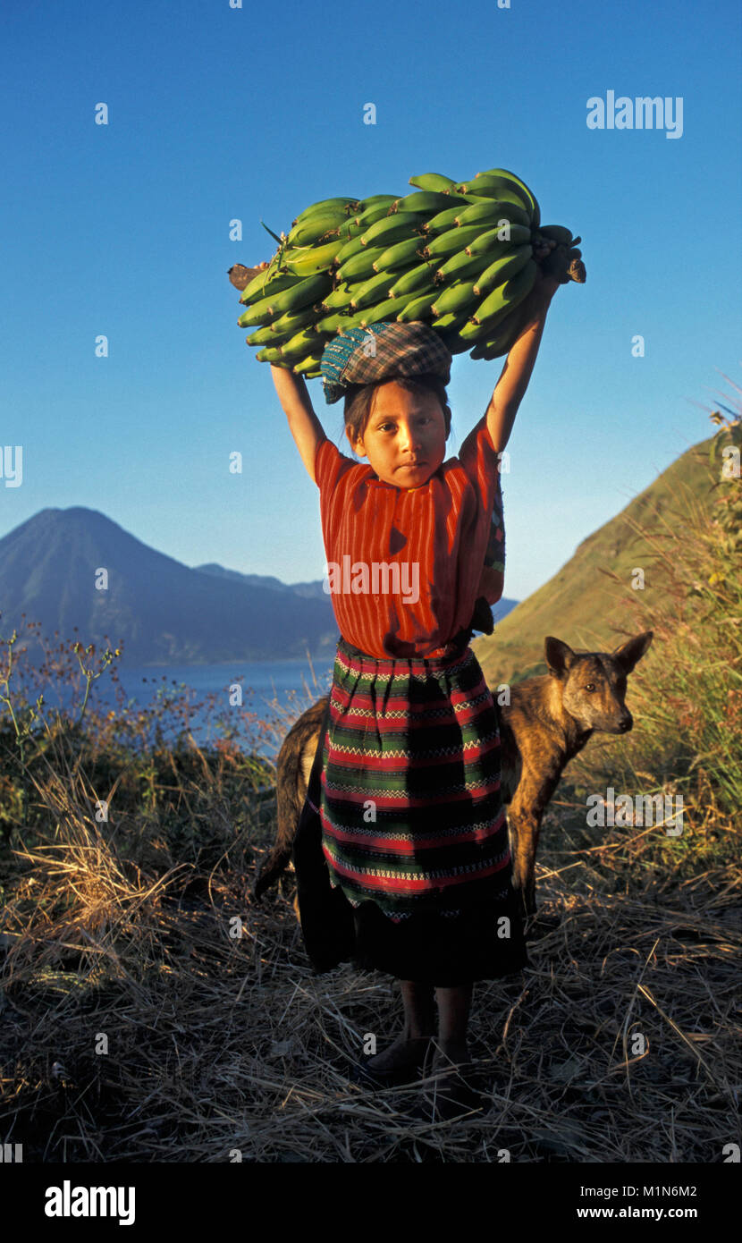 Guatemala. Panajachel. Lago de Atitlan. Maya girl carrying bananas on her head. Portrait. Stock Photo