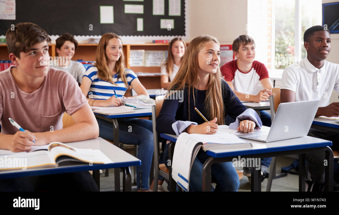 Students Listening To Female Teacher In Classroom Stock Photo - Alamy