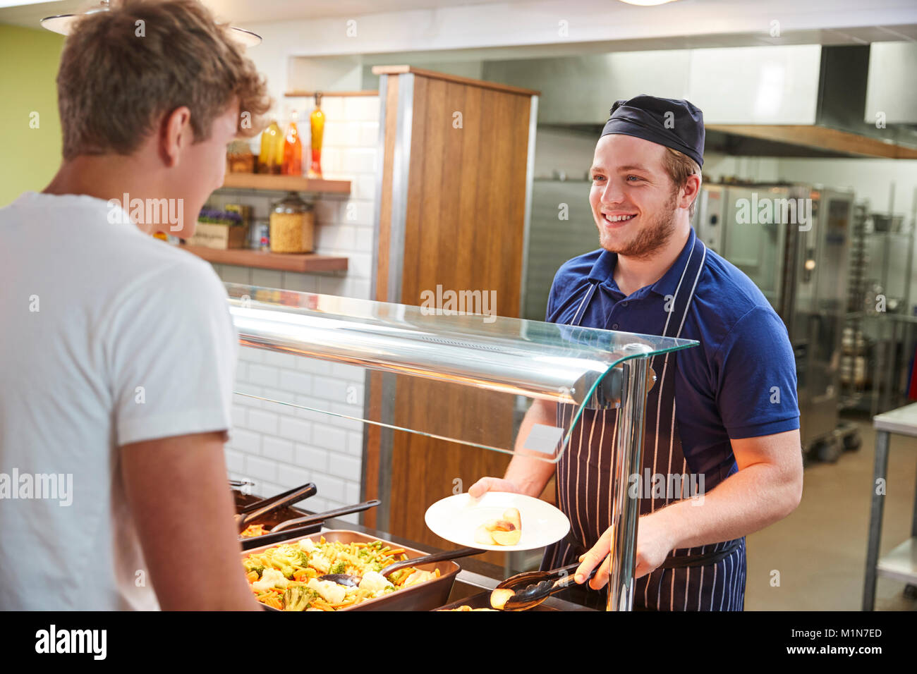 Teenage Students Being Served Meal In School Canteen Stock Photo Alamy