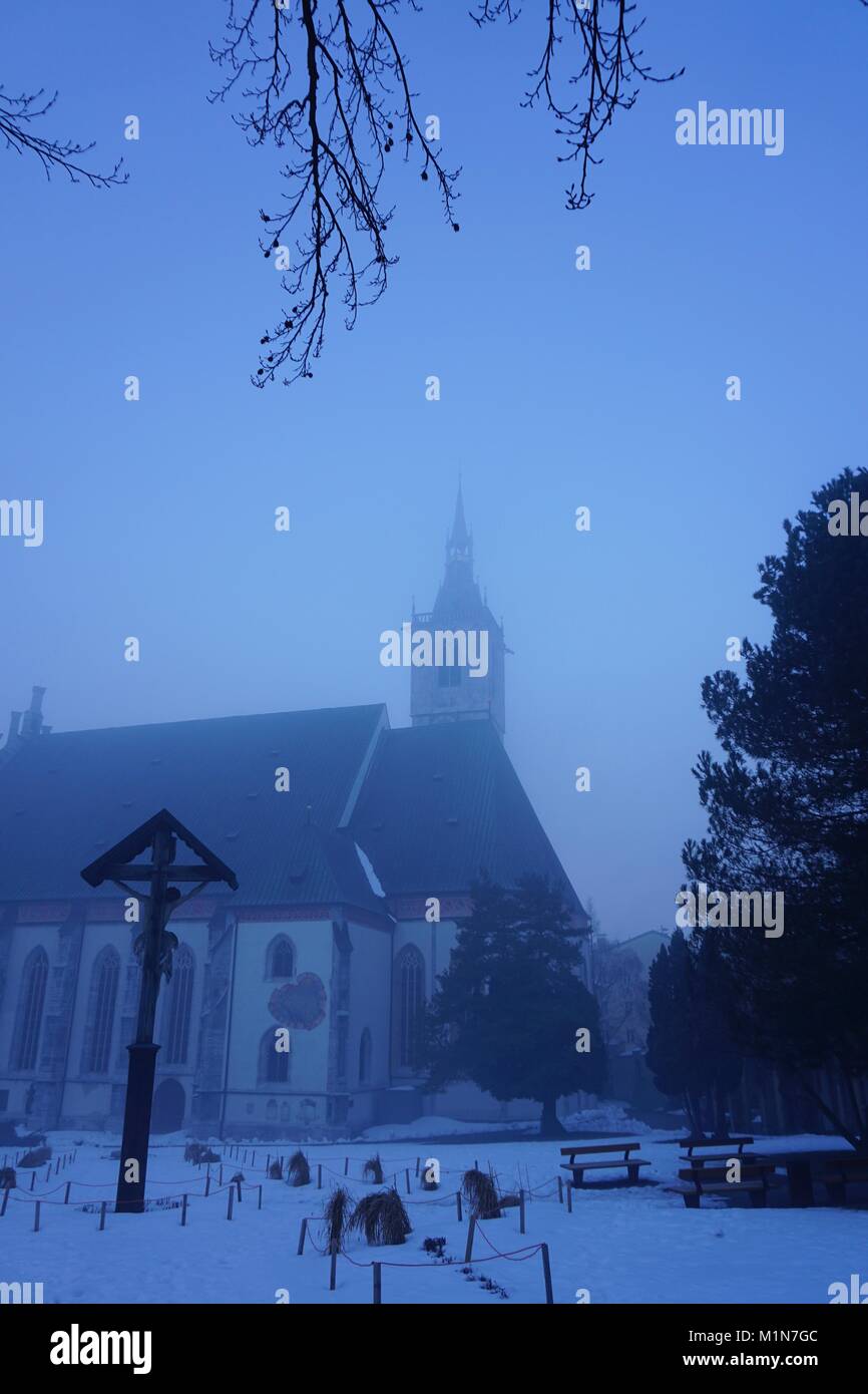 Schwaz Tirol Austria, church Maria Himmelfahrt on a foggy morning, January 2018 Stock Photo