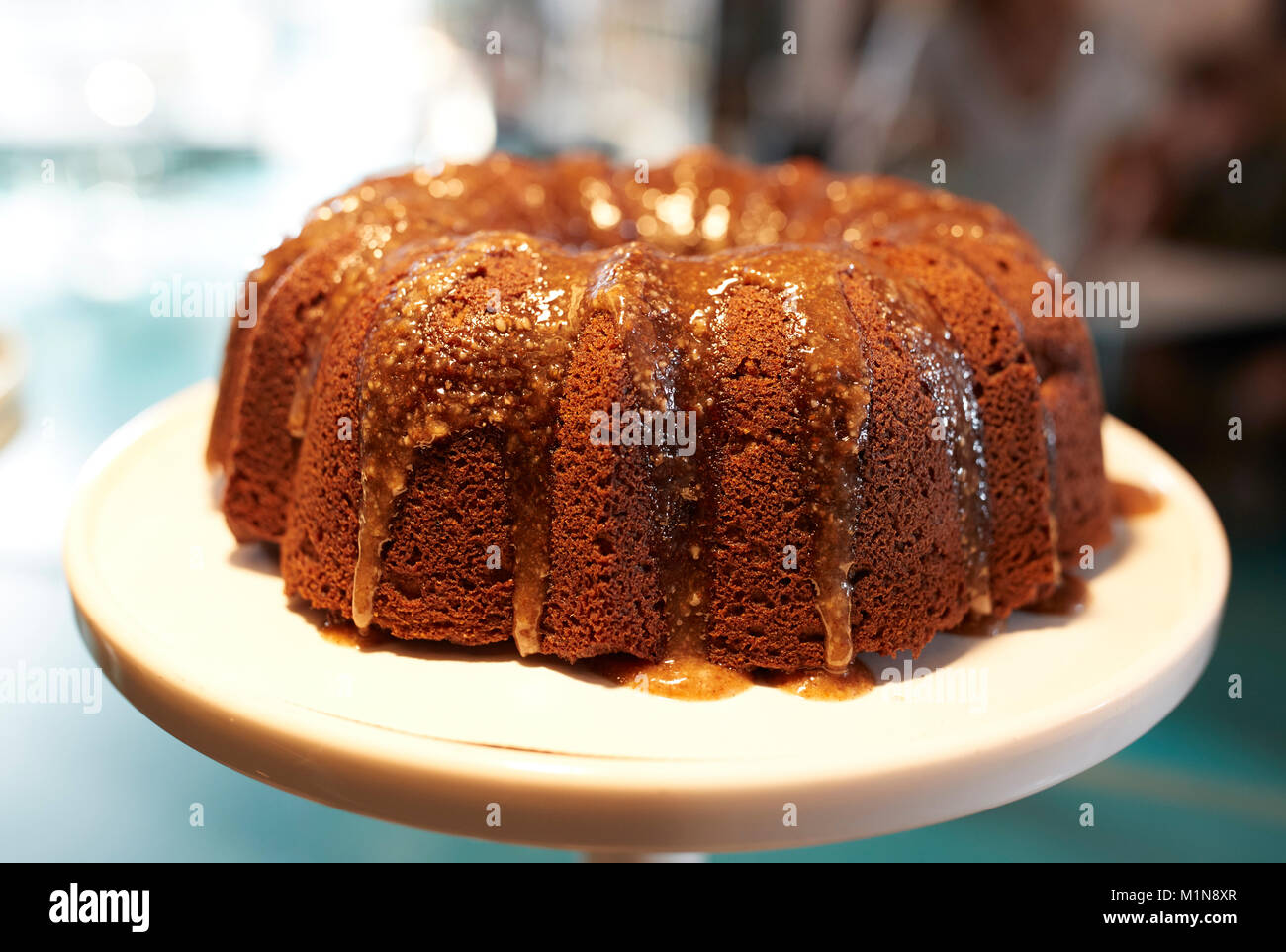 Freshly Baked Treacle Cake On Stand In Coffee Shop Stock Photo