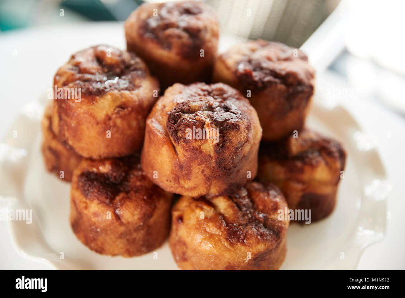 Display Of Freshly Baked Cinnamon Buns In Coffee Shop Stock Photo