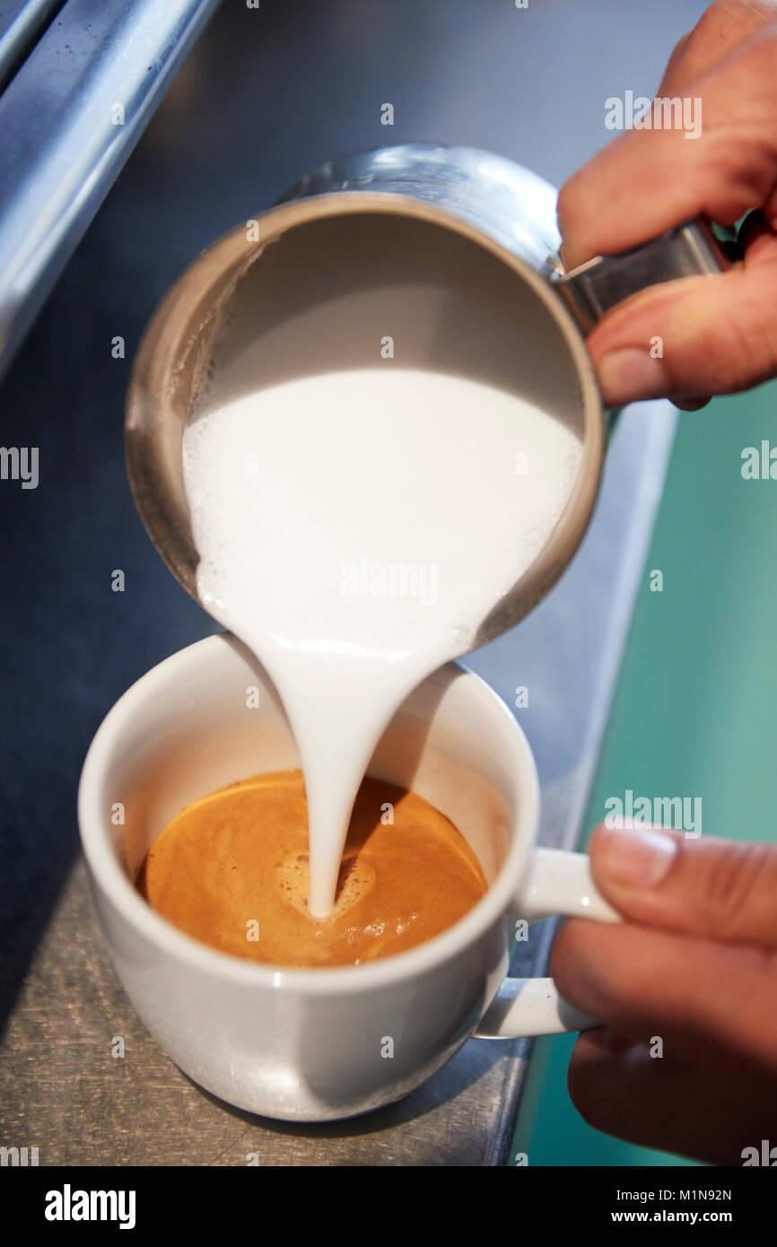 Close Up Of Male Barista Using Coffee Machine In Cafe Stock Photo