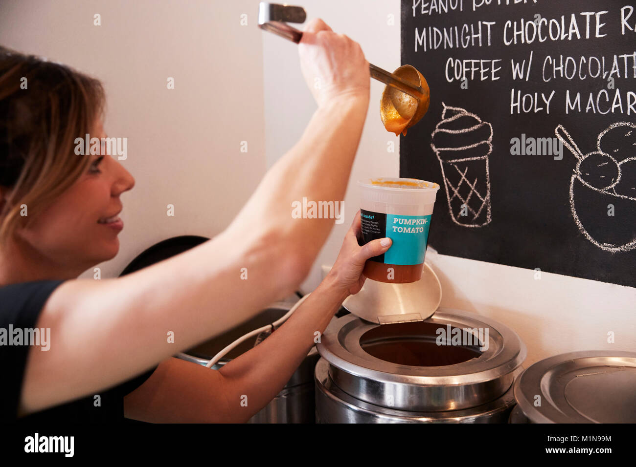 Waitress In Coffee Shop Serving Homemade Soup Stock Photo