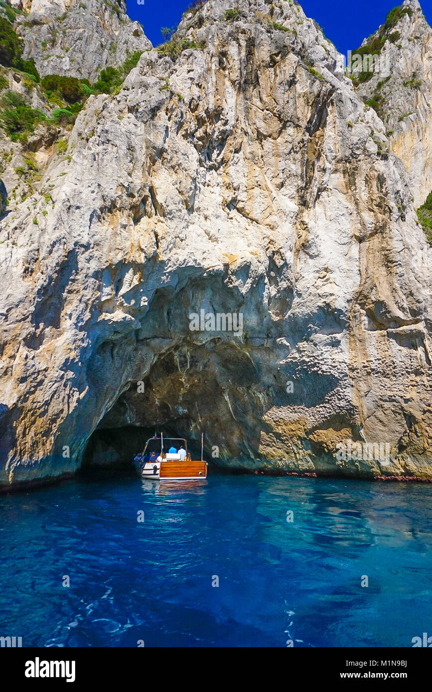 The White Grotto of the island of Capri, Italy.  Coastal Rocks on the Mediterranean Sea at Capri Island from a motor boat tour. Stock Photo