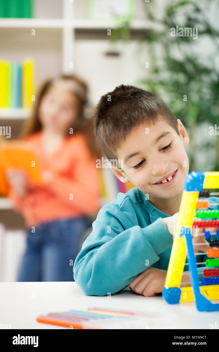 smiling young boy at home learning Stock Photo