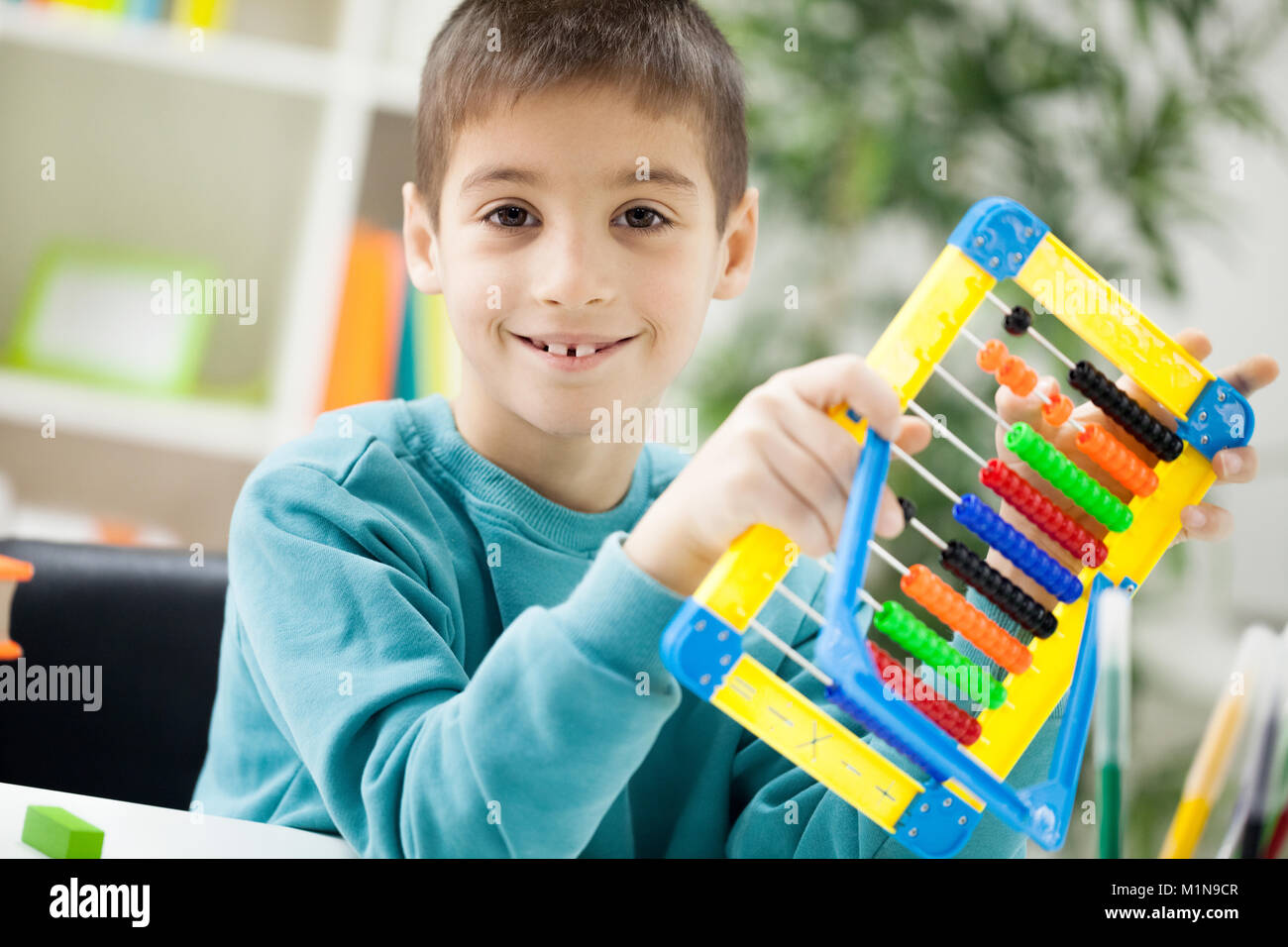 smiling young boy at home learning Stock Photo