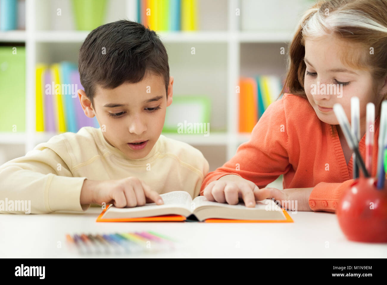 young brother and sister learn how to read Stock Photo