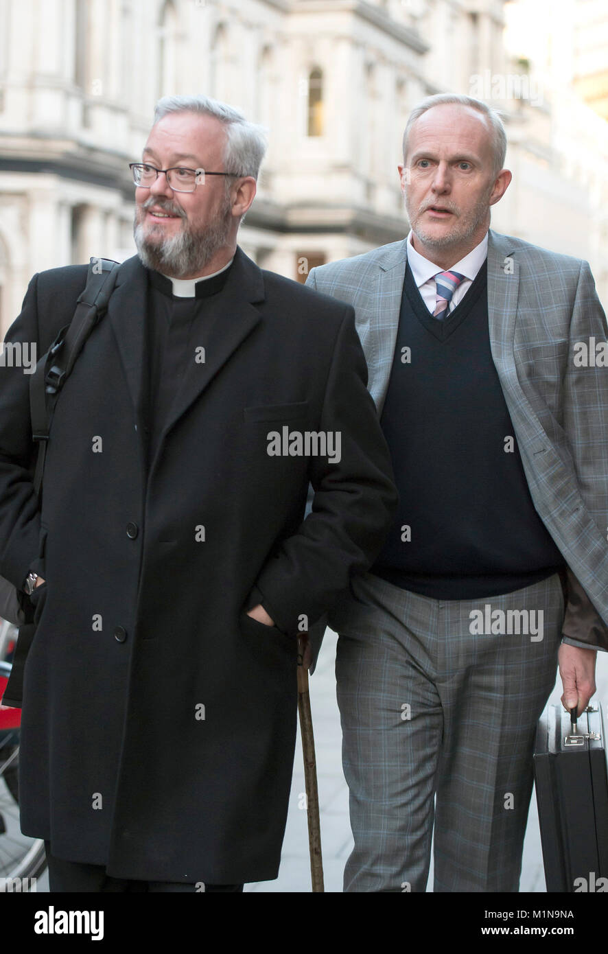 Canon Jeremy Pemberton (left) and husband Laurence Cunnington at the Royal Courts of Justice in London, as the gay priest who was prevented from working as a hospital chaplain after marrying his partner, has urged senior judges to find that he has suffered discrimination. Wednesday January 31, 2018. Canon Pemberton, a Church of England (C of E) priest for more than 30 years, had his permission to officiate revoked after he married his partner in April 2014. See PA story COURTS Pemberton. Photo credit should read: David Mirzoeff/PA Wire Stock Photo