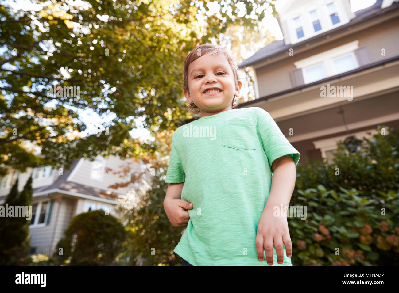 Portrait Of Young Boy Playing In Garden At Home Stock Photo