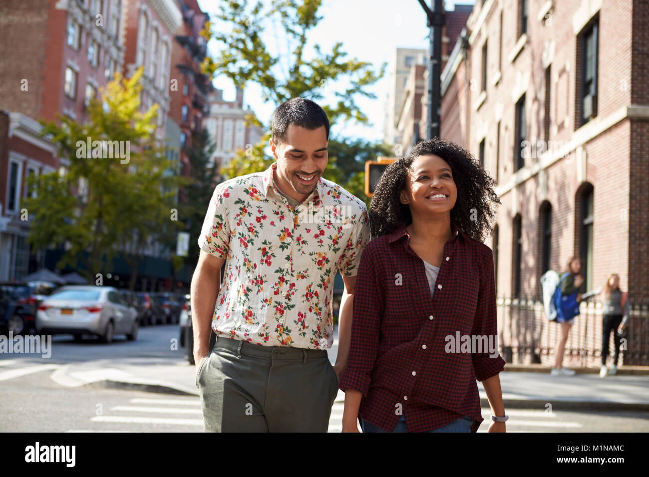 Young Couple Walking Along Urban Street In New York City Stock Photo