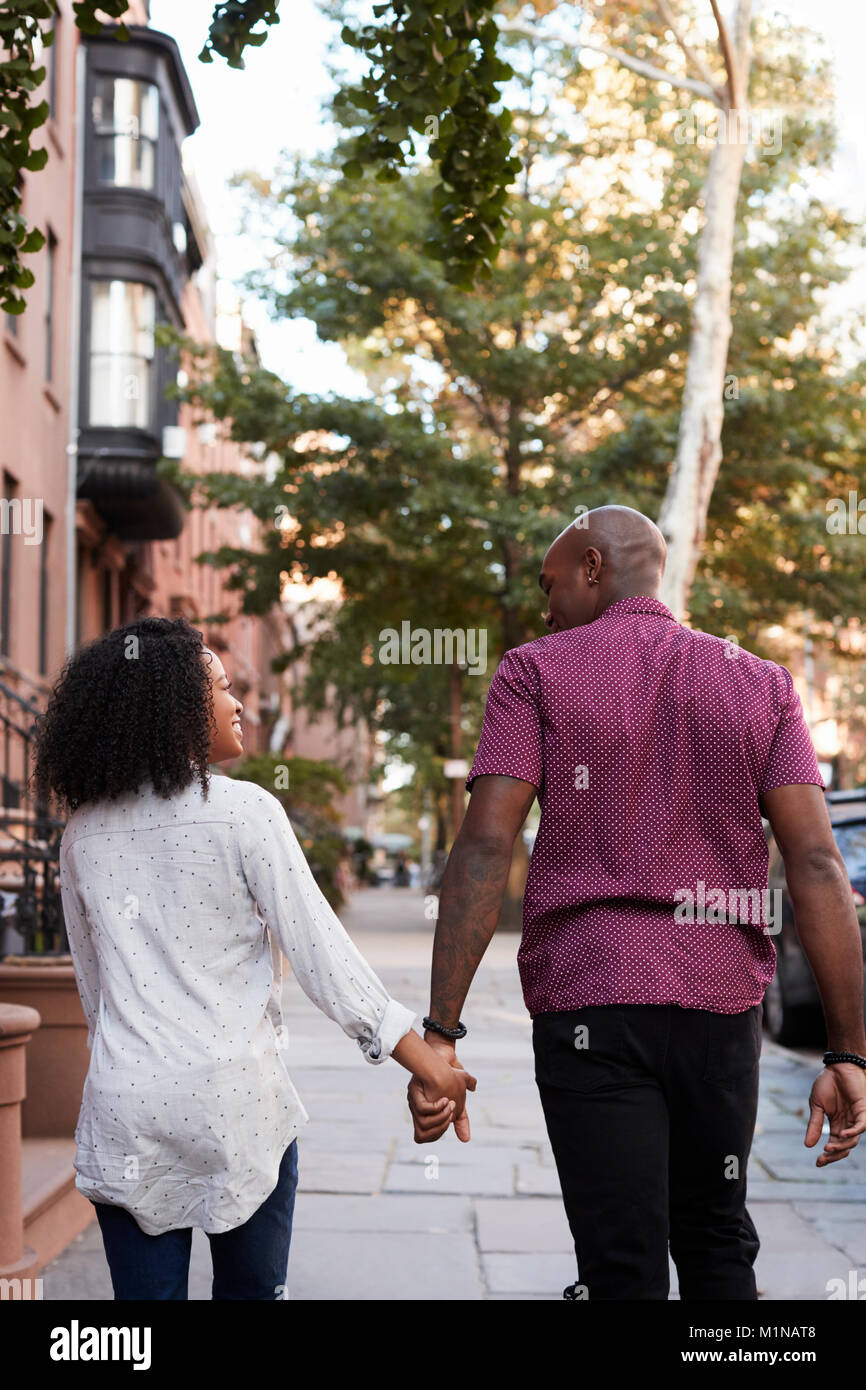 Rear View Of Couple Walking Along Urban Street In New York City Stock ...