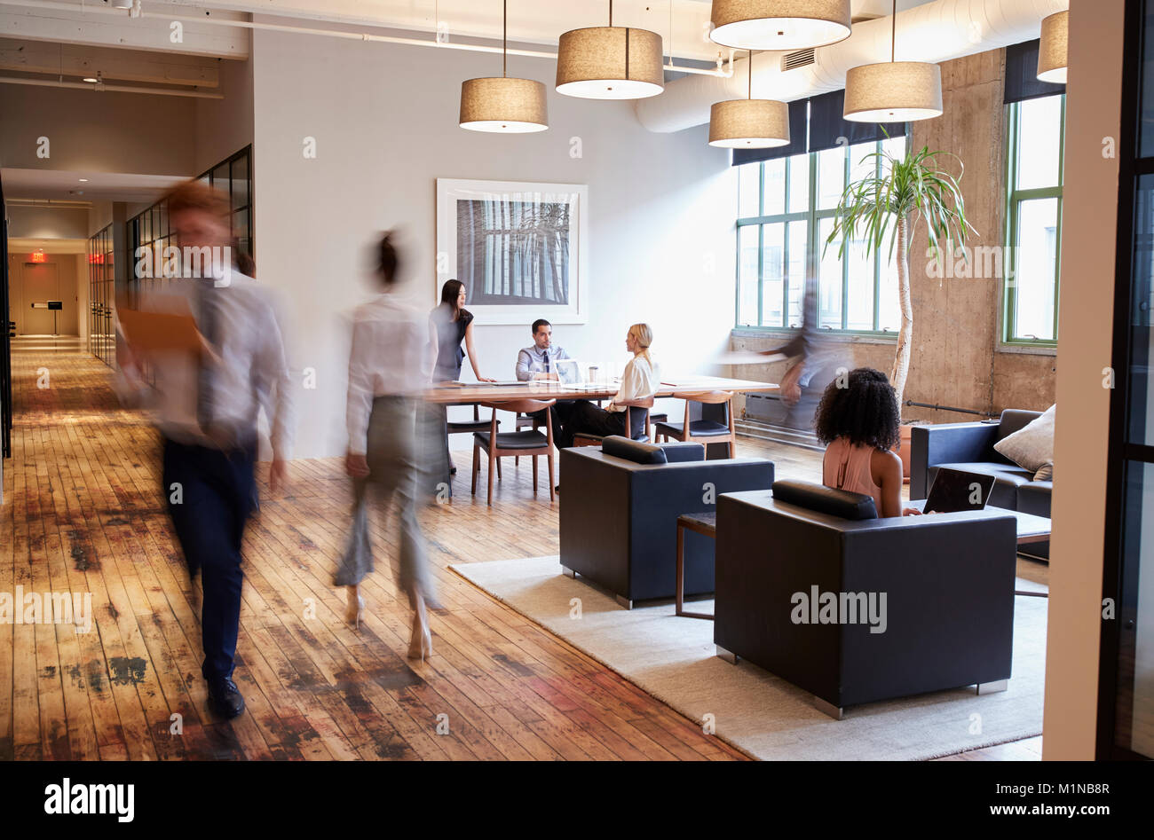 Business people at work in a busy luxury office space Stock Photo