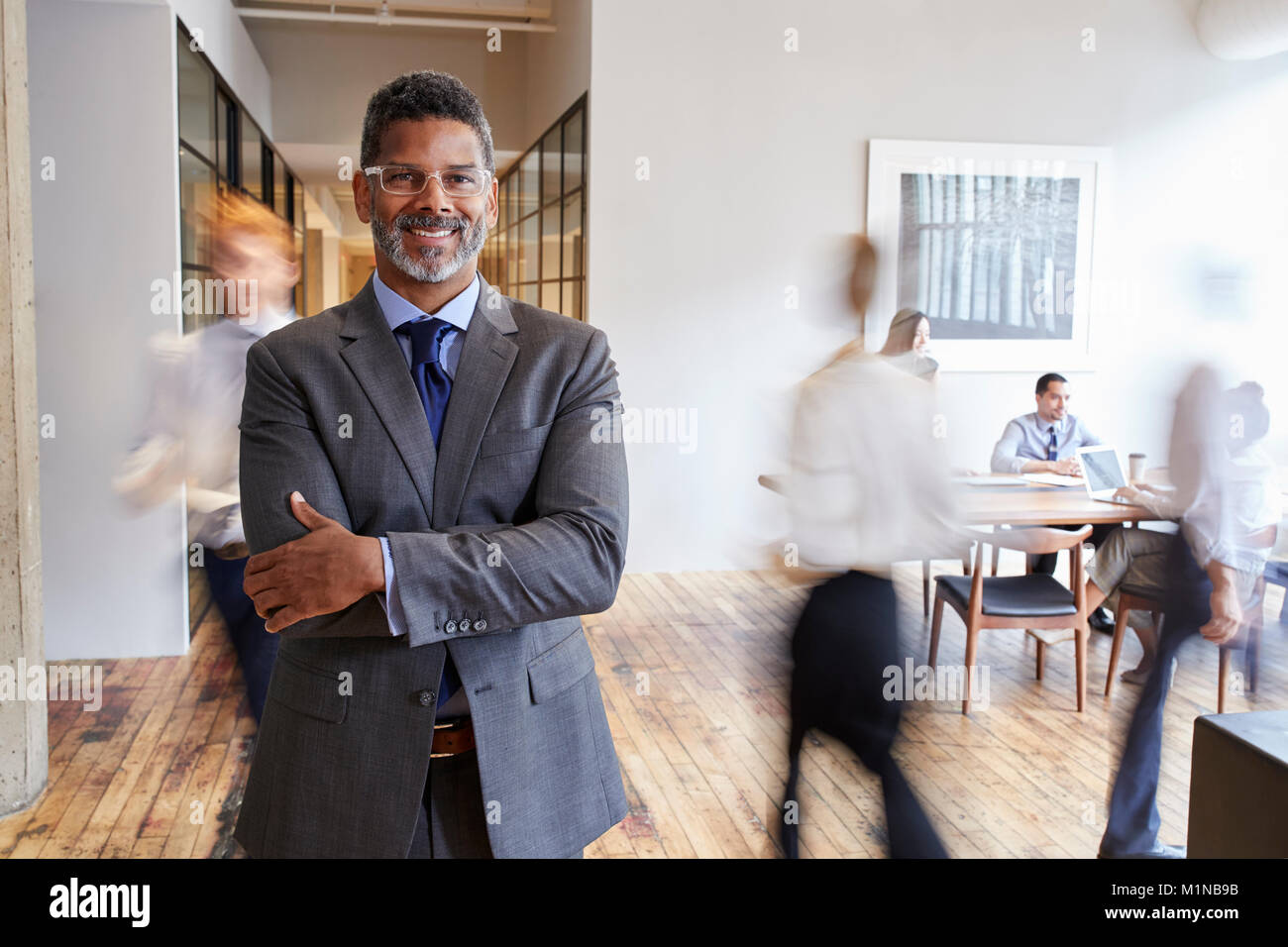 Portrait of middle aged black man in a busy modern workplace Stock Photo