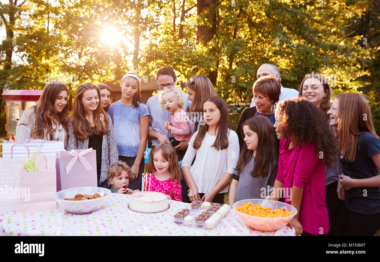 Friends and family in garden celebrating a child’s birthday Stock Photo