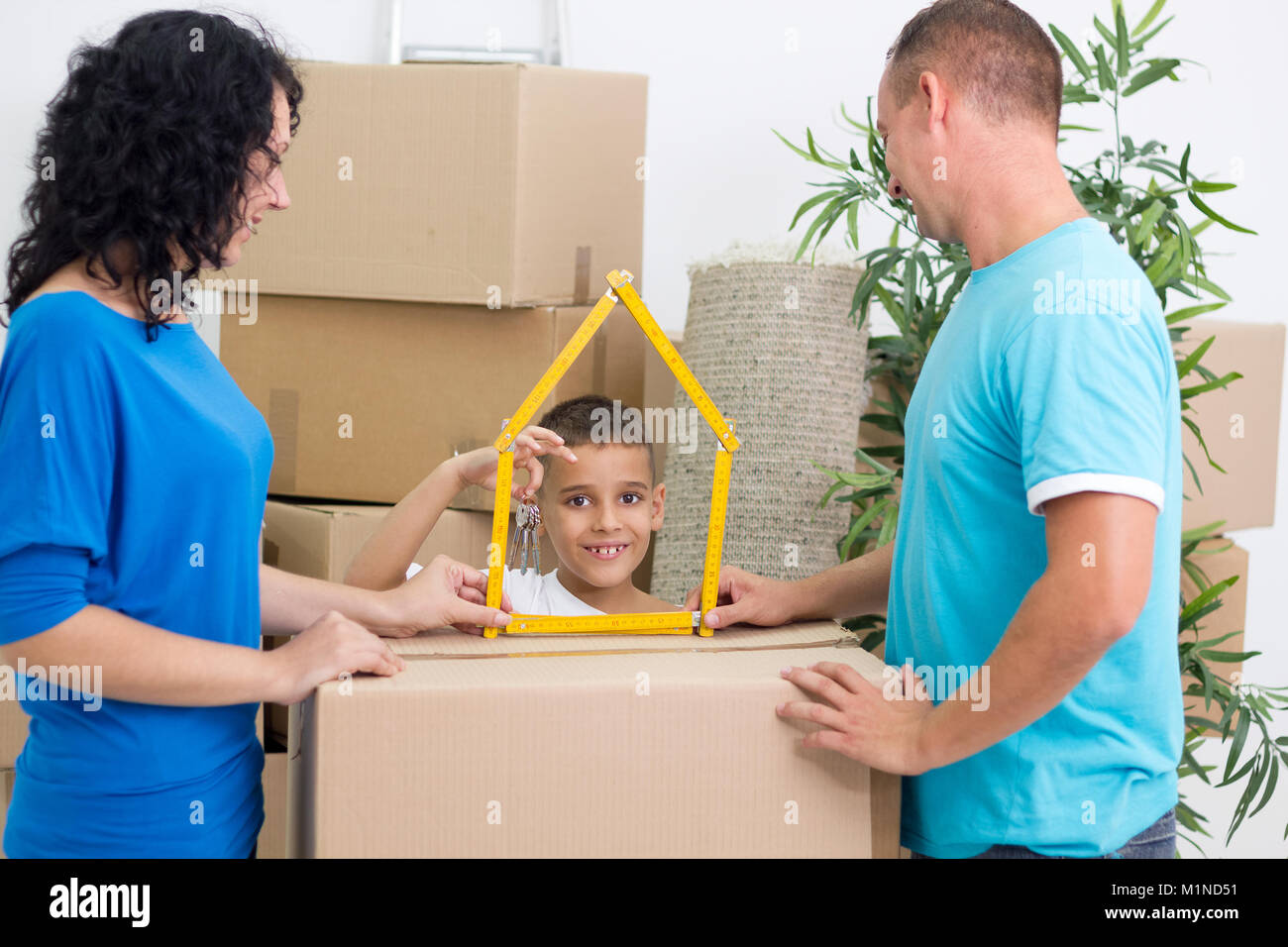 Happy family moved into a new house son holds the key Stock Photo