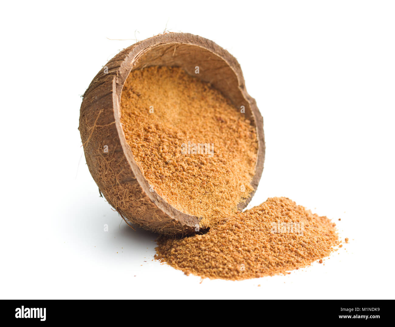 Sweet coconut sugar in coconut shell isolated on white background. Stock Photo