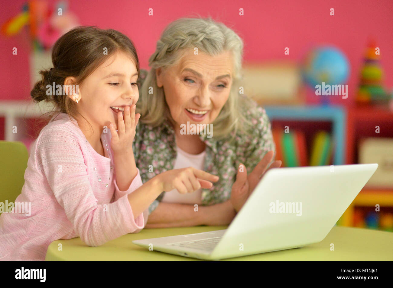 girl with grandmother using laptop Stock Photo - Alamy