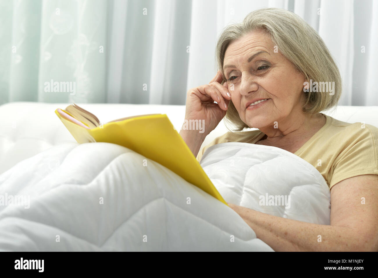 beautiful senior woman with book Stock Photo