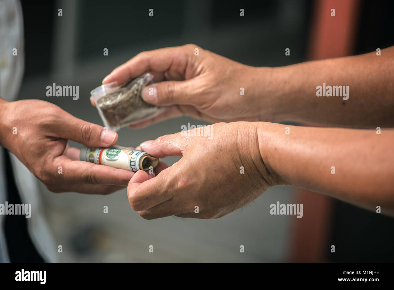 Drug addict buying narcotics and paying Stock Photo