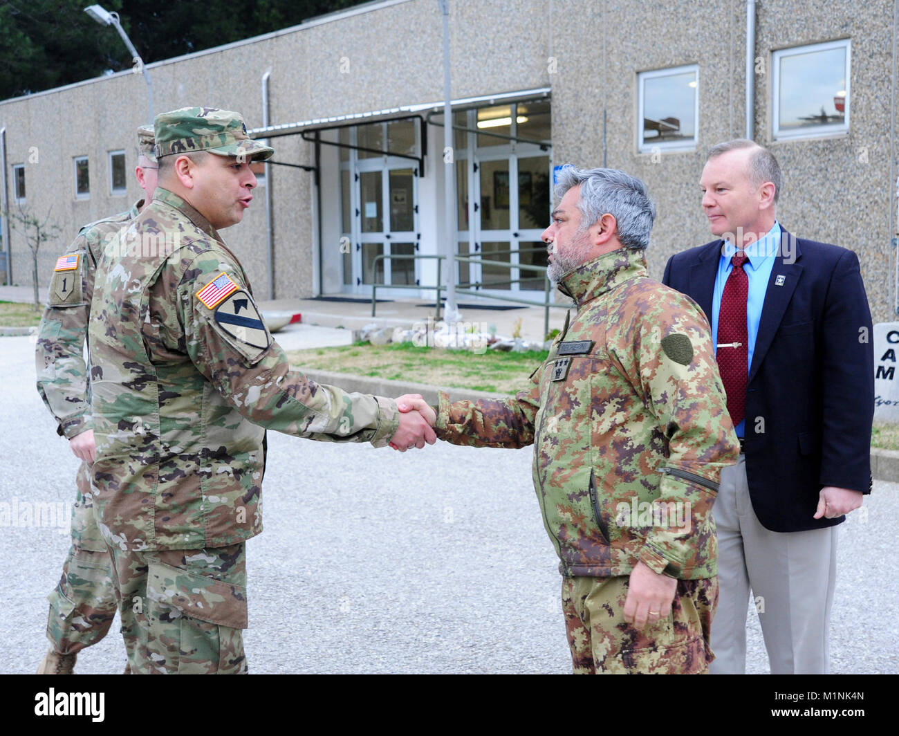 (From left) U.S. Army Lt. Col. Ismael B. Natividad, Training Support Activity Europe (TSAE) Director, greets Italian Army Col. Marco Becherini, Folgore (ABN) Brigade Training Center Commander and James V. Matheson, Regional Training Support Division South Chief, 7th Army Training Command, during the TSAE Director visit at Lustrissimi Training Area, Livorno, Italy, Jan 30, 2018.( Stock Photo