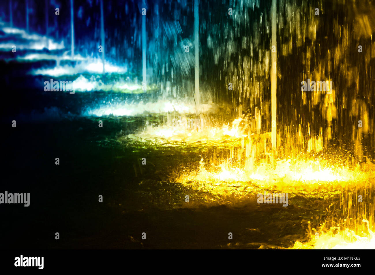 A line of city fountains with illumination at night Stock Photo - Alamy