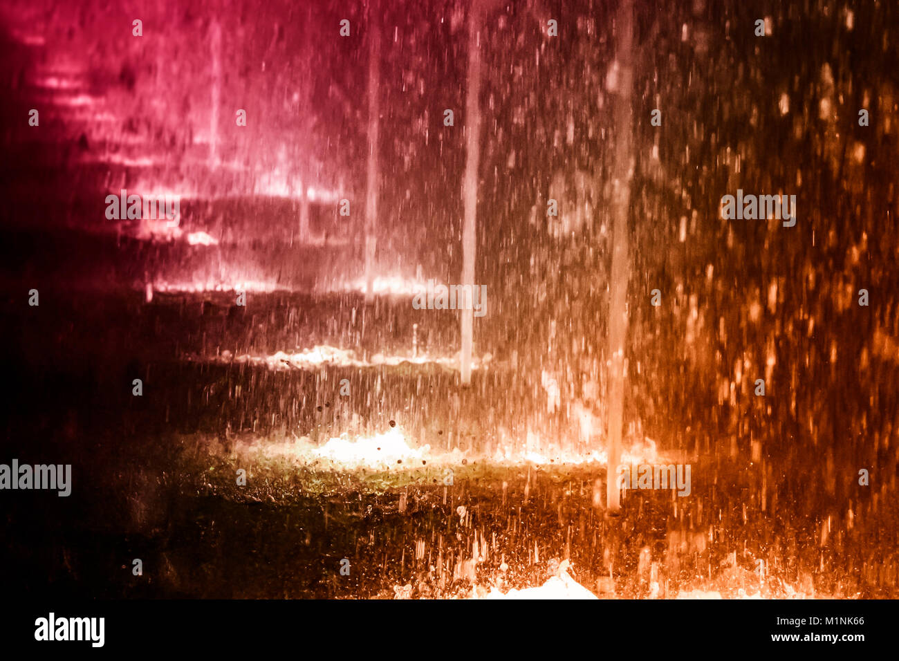 A line of city fountains with illumination at night Stock Photo - Alamy