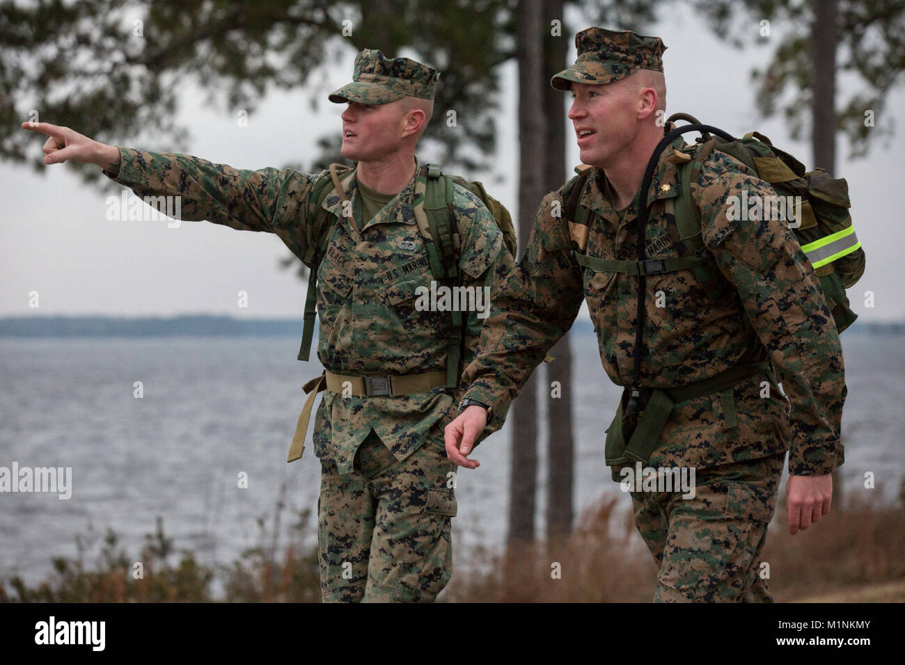 U.S. Marine Corps 1st Sgt. Jeremy A. Black, 2nd Recon Battalion, 2nd Marine Division (2d MARDIV), left, and Maj. William M. Willis, 2nd Recon Battalion, 2d MARDIV, walk during the 2d MARDIV 50-mile challenge hike on Camp Lejeune, N.C., Jan. 30, 2018. The hike was held to challenge officer’s and enlisted Marines’ skill and will as well as honor tradition following President Theodore Roosevelt’s Executive Order 989. (U.S. Marine Corps Stock Photo