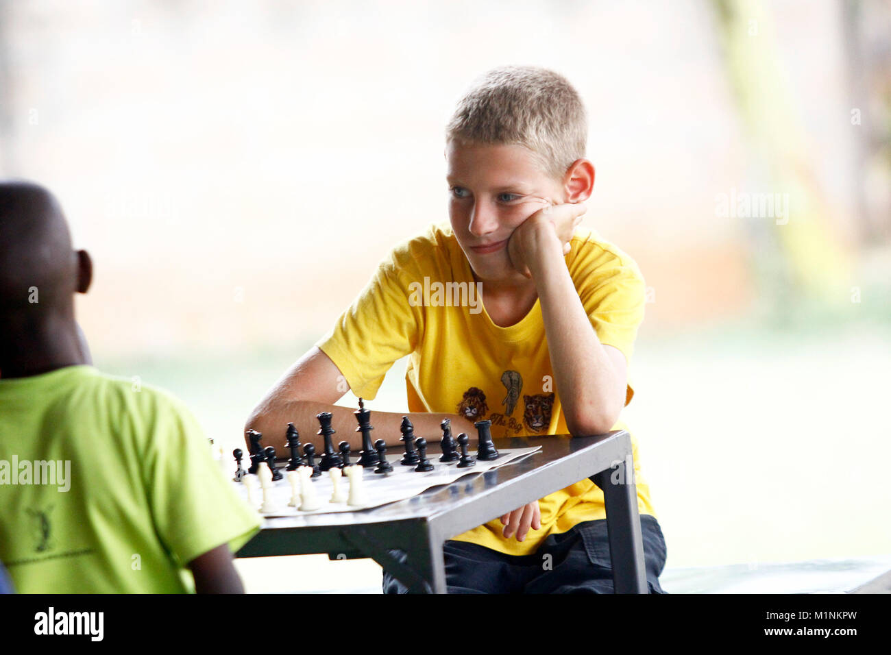 Young white child playing a game of chess on large chess board. Chess board  on table in front of school boy thinking of next move by Len44ik Vectors &  Illustrations with Unlimited