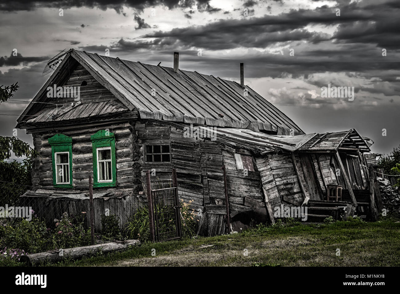 An old rickety dilapidated residential log wooden house. Stock Photo