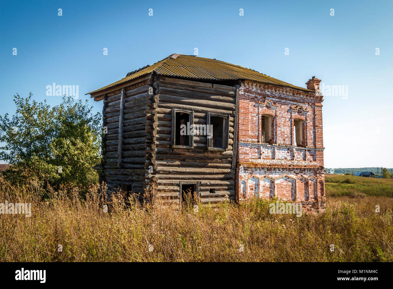 The Old Abandoned Historic Building Of Red Brick And Logs Stock