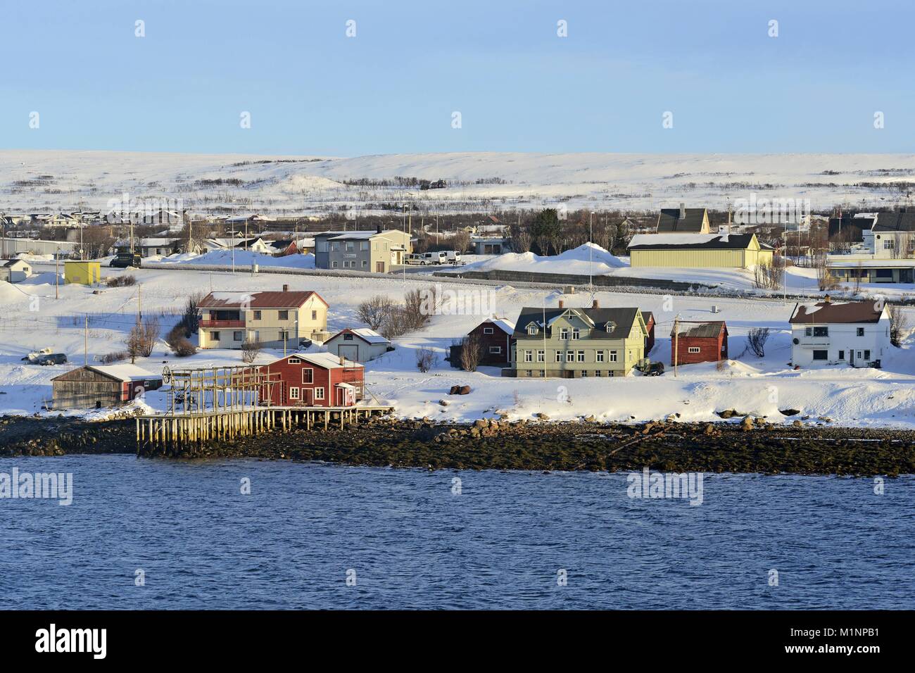 Several buildings from the Norwegian town Vadsø by the stony shore of ...