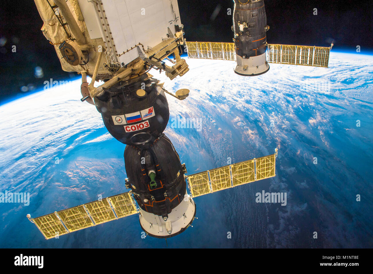 Outer Space-December 30, 2017: Awesome view of the planet Earth and the Soyuz spaceship docked to the ISS. This image elements furnished by NASA Stock Photo