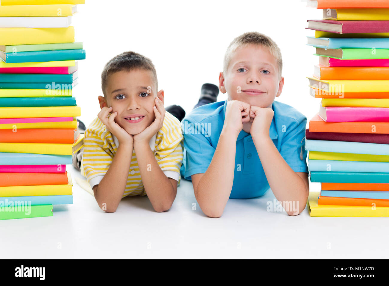 two boys surrounded with books two boys with books Stock Photo