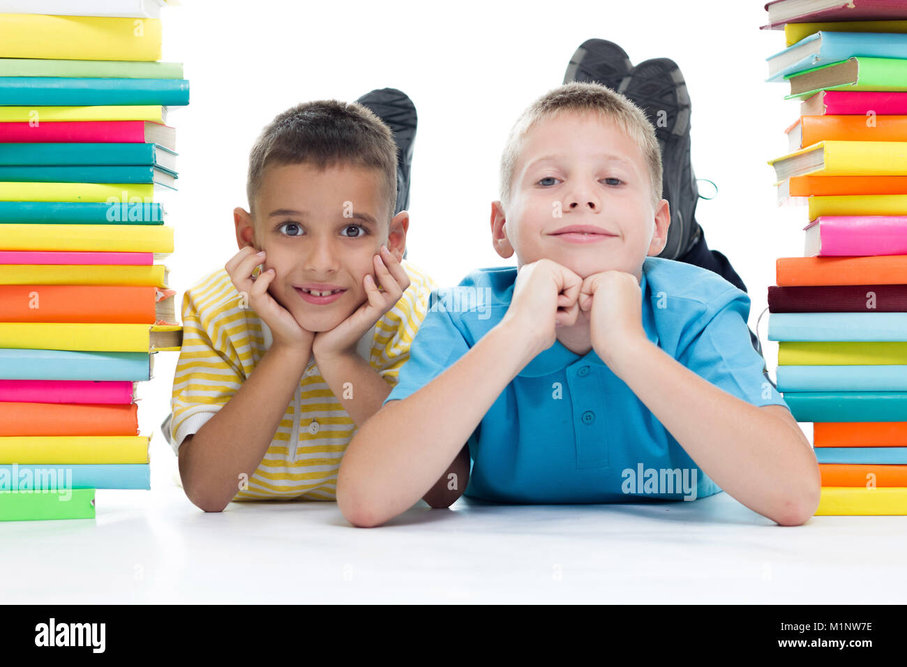 two smiling boys surrounded with books Stock Photo