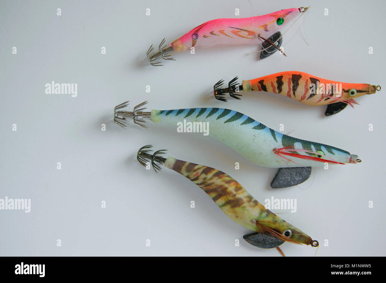 Isolated colorful plastic fishing baits on white background, space for