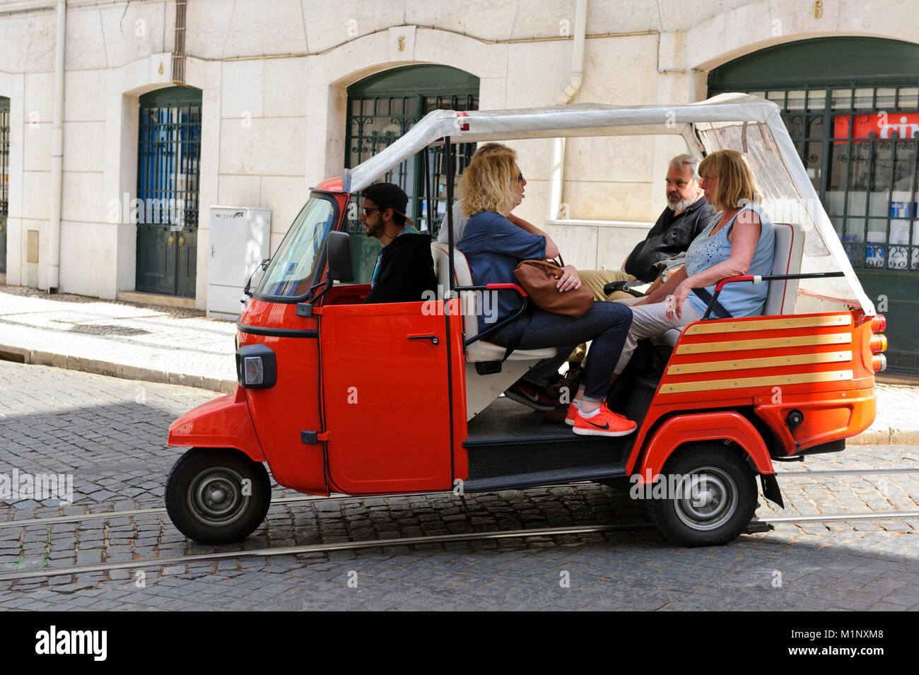 A tuk tuk with passengers in Commerce Square, Lisbon, Portugal Stock Photo