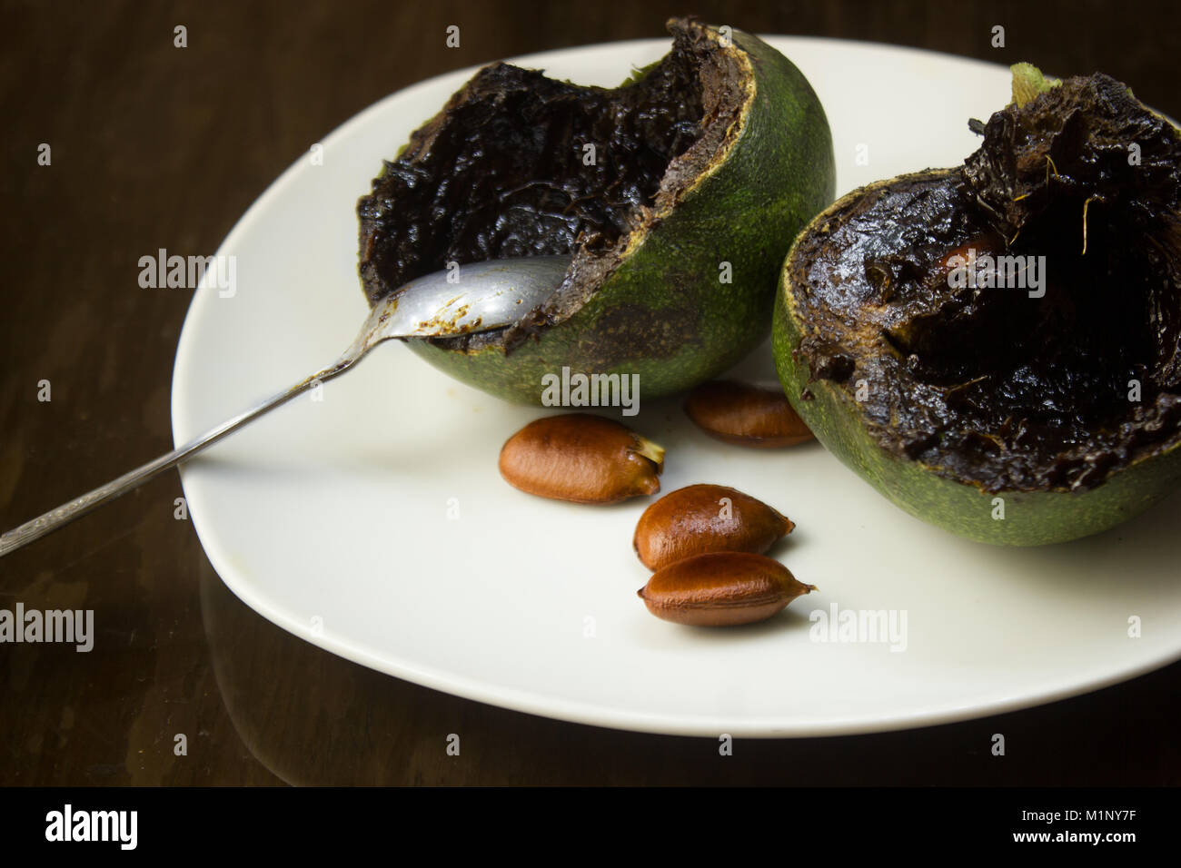 Black sapote pudding on white plate, mexican exotic fruit Stock Photo